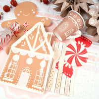 Gingerbread table styled with pink striped pink paper napkins
