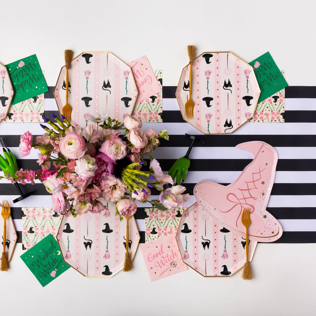 Overhead table styled with pink witch hat paper plates, chic Pink Halloween Plates look