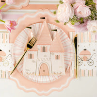Close place setting showing carriage princess napkins, gold flatware, pink runner