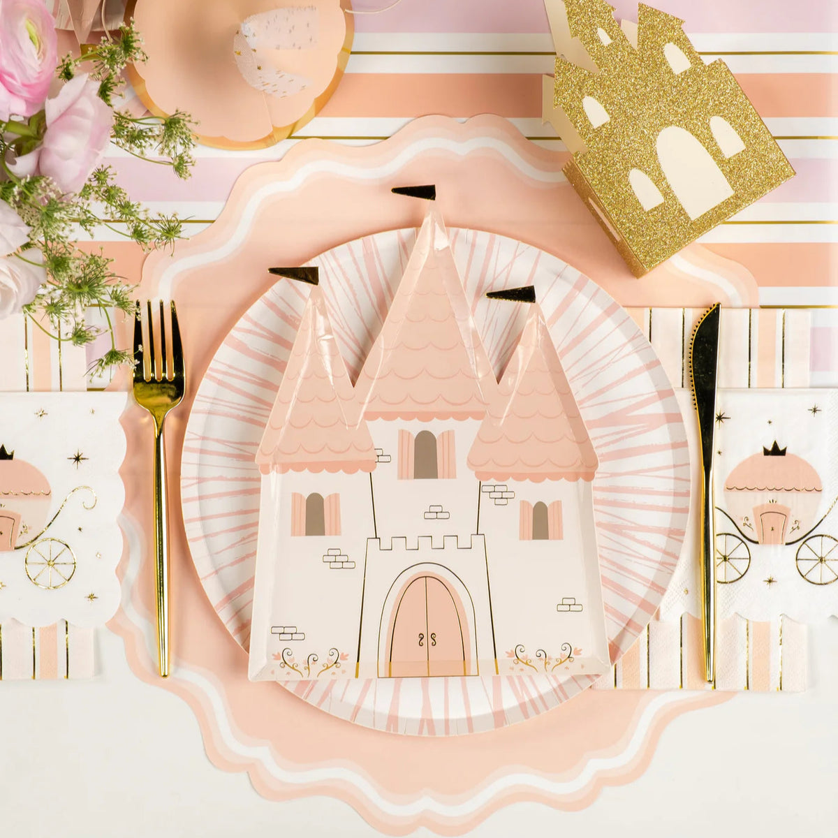 Place setting with castle plate and carriage princess napkins on pink stripe runner