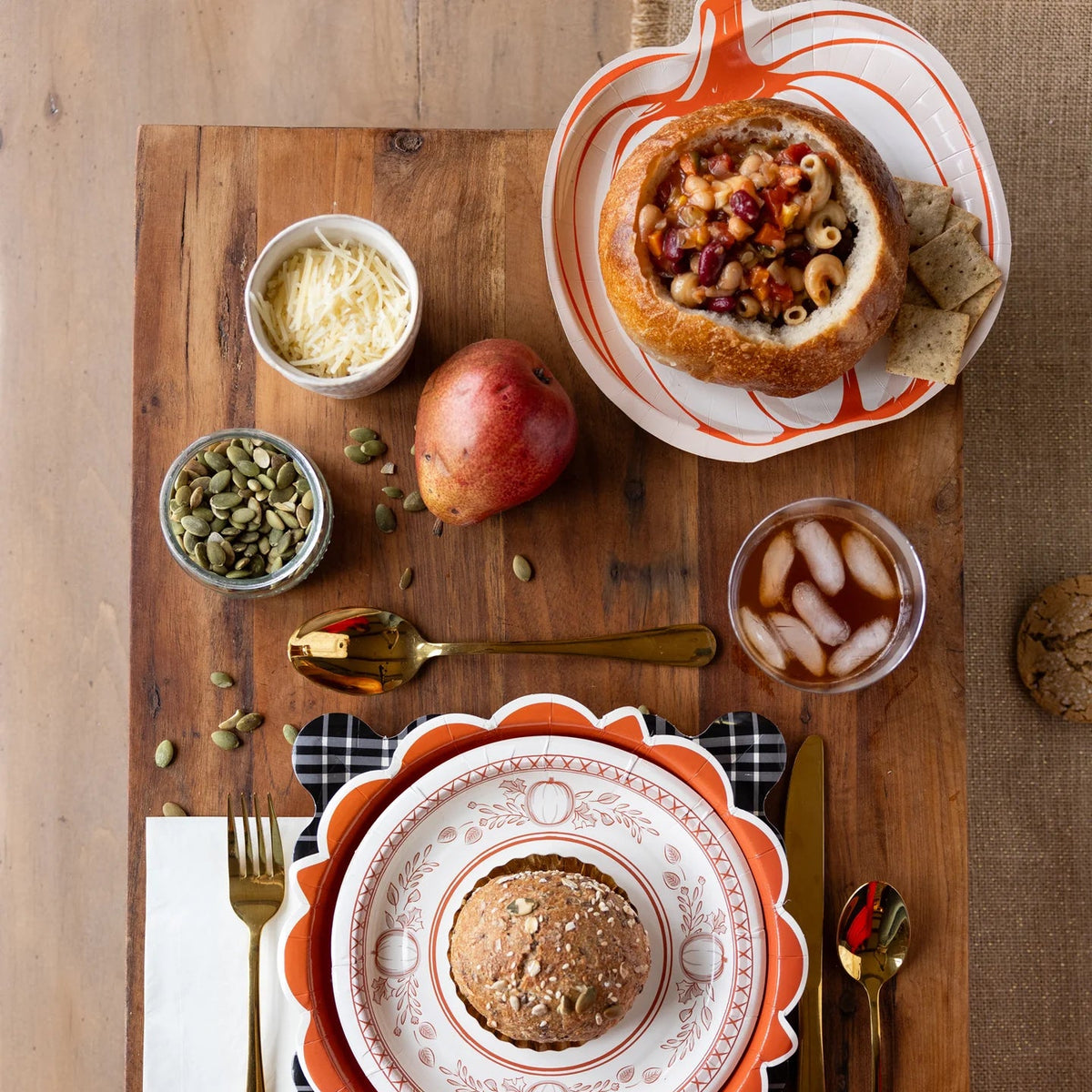 Layered fall place setting with pumpkin plates and black check charger