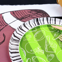 Game day setting with Radiance rim under green plate, party ready Paper Plates