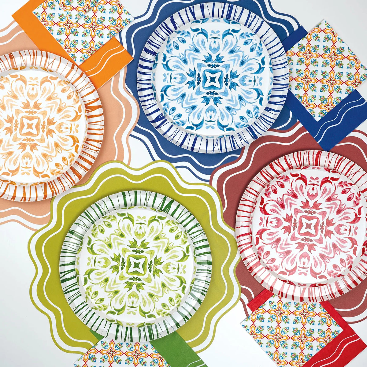 Layered tablescape mixing Talavera plates with Radiance sunburst rims in multiple colors