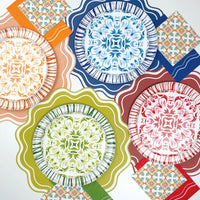 Layered tablescape mixing Talavera plates with Radiance sunburst rims in multiple colors