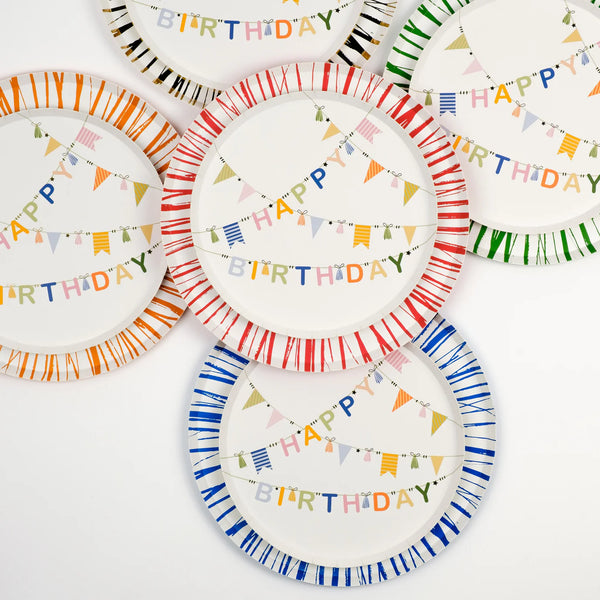 Overhead of Radiance plates with sunburst rims, orange included, styled with Happy Birthday centers