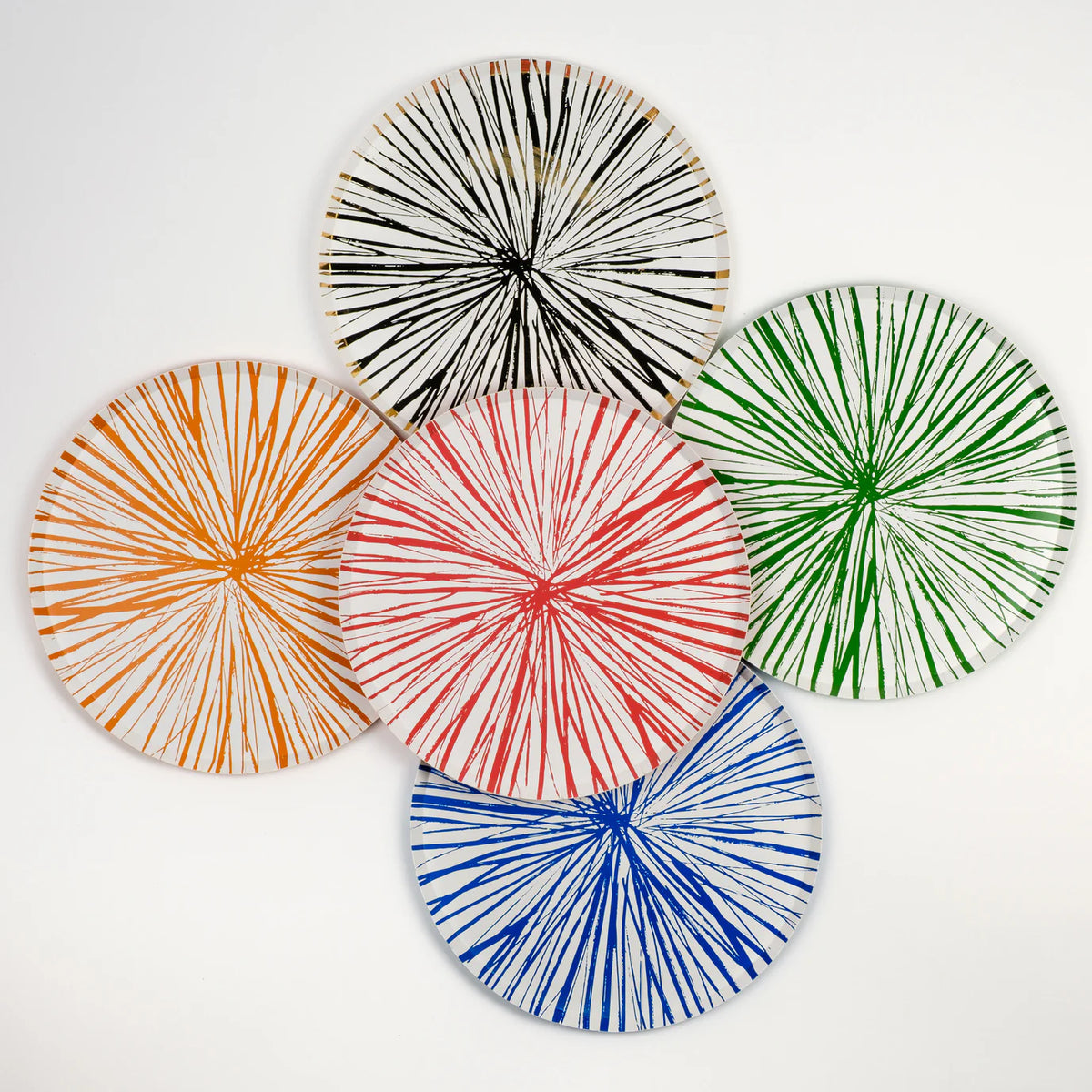 Backs of Radiance plates showing sunburst pattern in orange, black, green, red, and blue