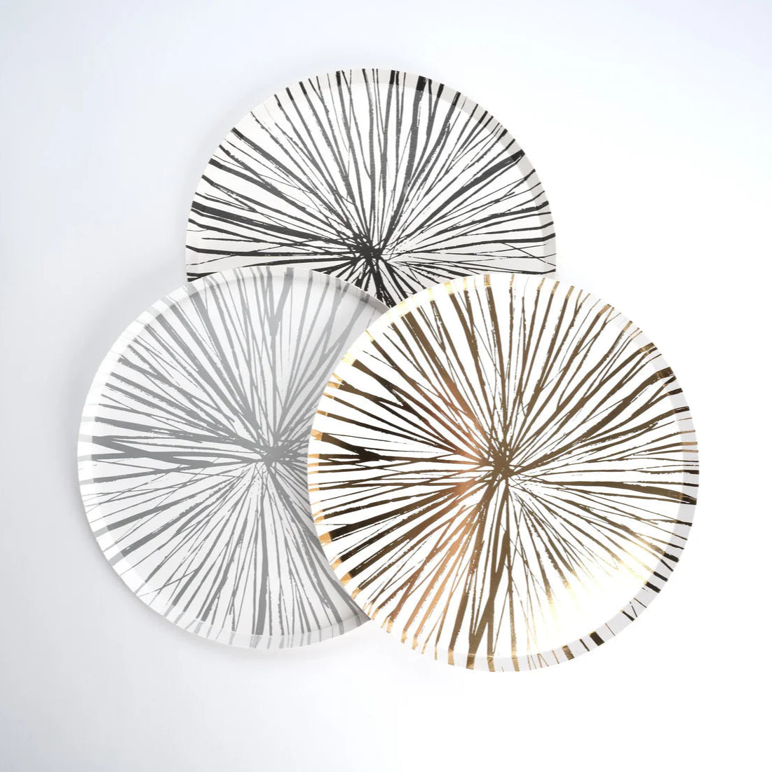 Trio of sunburst plates in black, gray, and gold, perfect for New Years tables