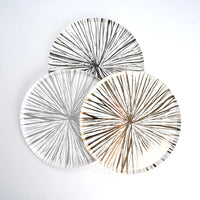 Trio of sunburst plates in black, gray, and gold, perfect for New Years tables