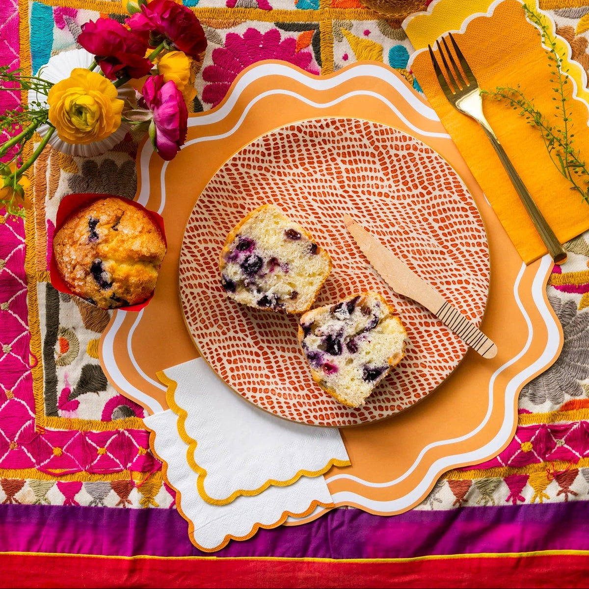 Bright embroidered table with orange edge paper cocktail napkins, cozy fall napkins look