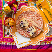 Bright embroidered table with orange edge paper cocktail napkins, cozy fall napkins look