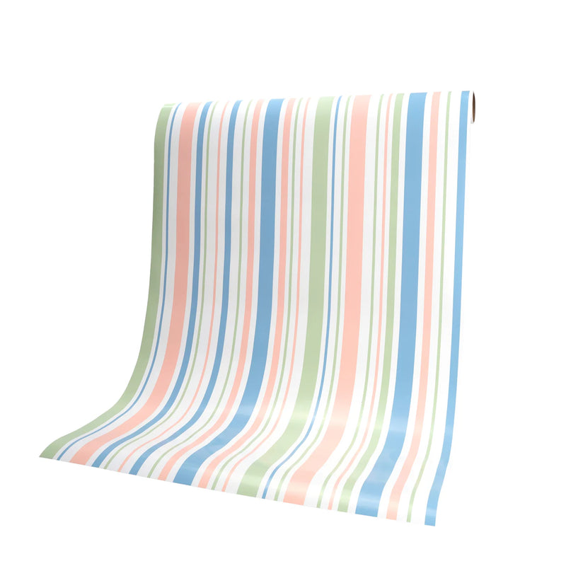 Pastel stripe paper table runner draped from roll, ready to cut to size for spring parties