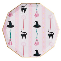 Decorative plate with Halloween-themed design featuring black cats, witch hats, and brooms on a pink background.