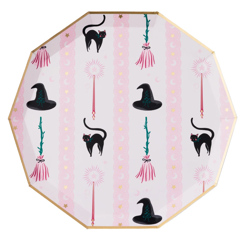 Decorative plate with Halloween-themed design featuring black cats, witch hats, and brooms on a pink background.