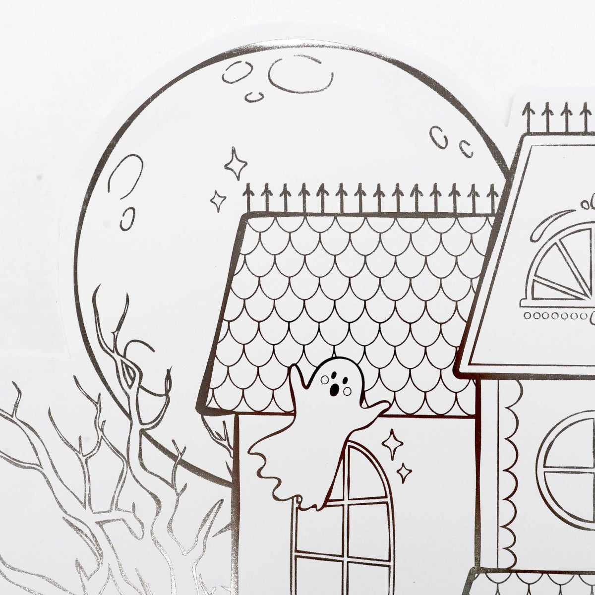 Detail shot of the top left corner of the placemat featuring a large line-art moon and a floating ghost.