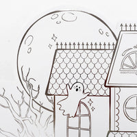 Detail shot of the top left corner of the placemat featuring a large line-art moon and a floating ghost.