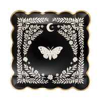 Top view of black moonlight moth square paper plate with white moth illustration and gold foil scalloped edge.