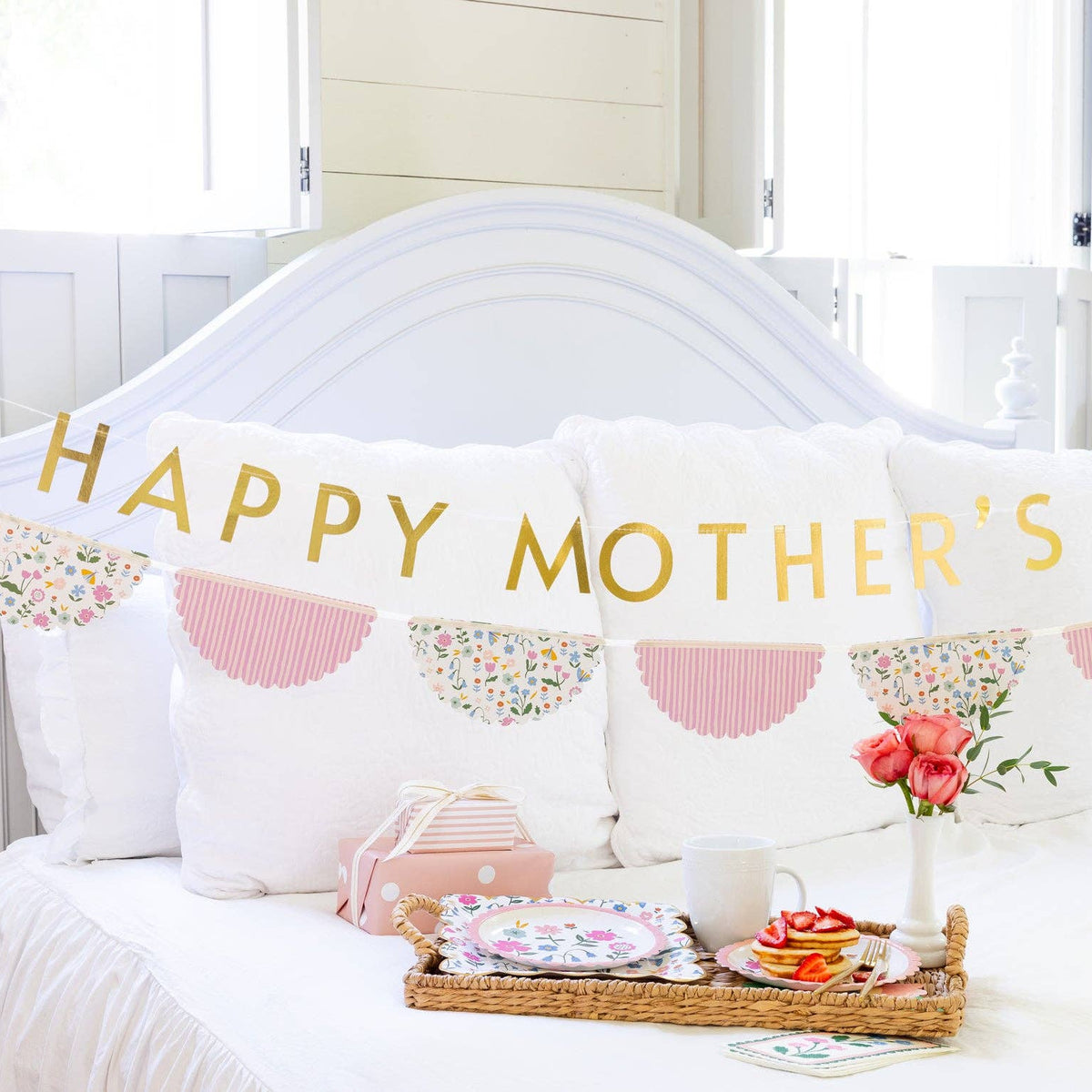 Mother’s Day banner displayed above bed with breakfast tray and flowers