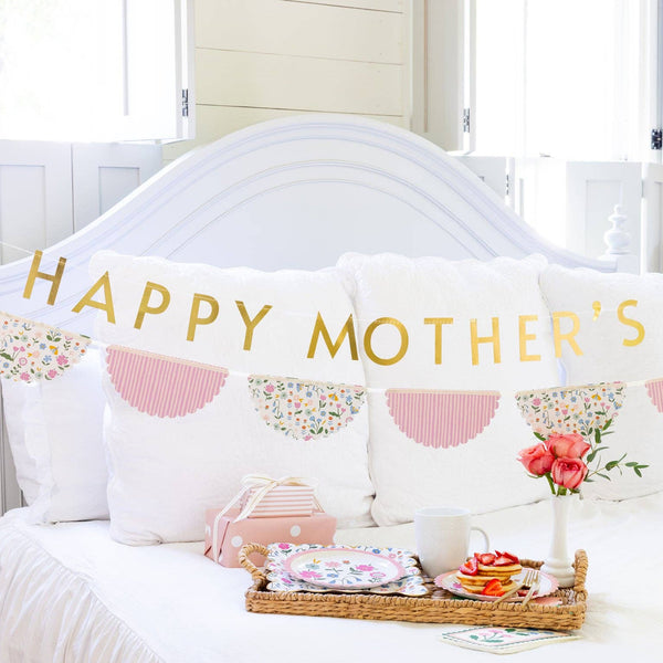 Mother’s Day banner displayed above bed with breakfast tray and flowers