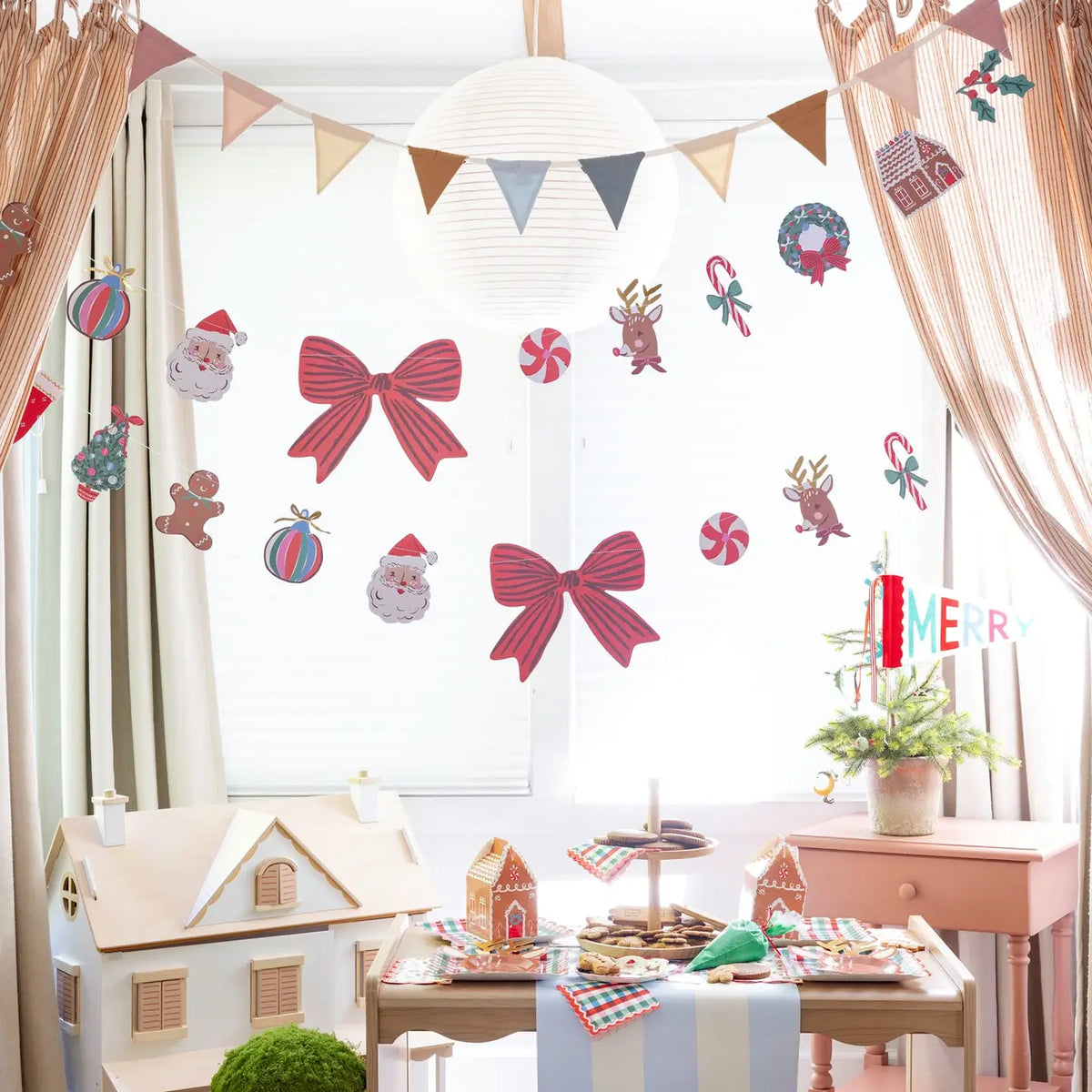 Kids' Christmas party table with gingham cocktail napkins on a cookie stand under Christmas icon garlands; garlands, pennant, treat boxes, plates, and runner shown separately, not included