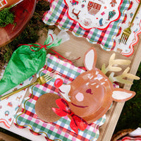 Multicolor gingham square paper plates layered under a reindeer plate and a Merry + Bright plate; other plates, napkins, and fork shown separately, not included