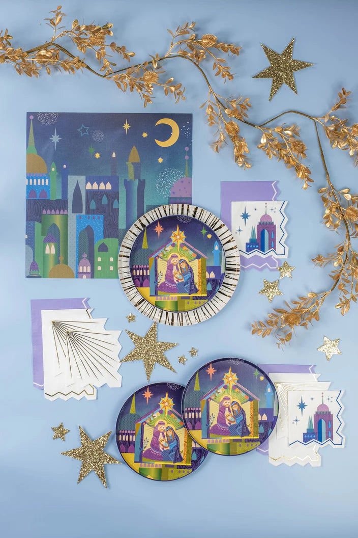 Flat lay with cityscape mats, star napkins, and Holy Family plates