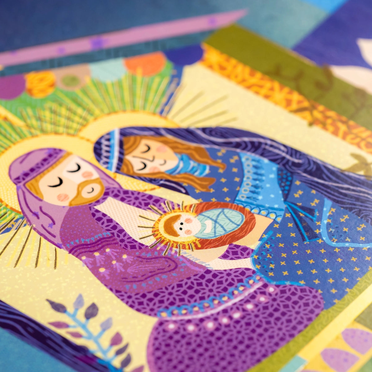 Close detail of Mary, Joseph, and Baby Jesus with golden halo accents
