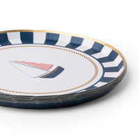 Angled stack of nautical sailboat paper dessert plates with a navy-and-white striped border and gold rim.