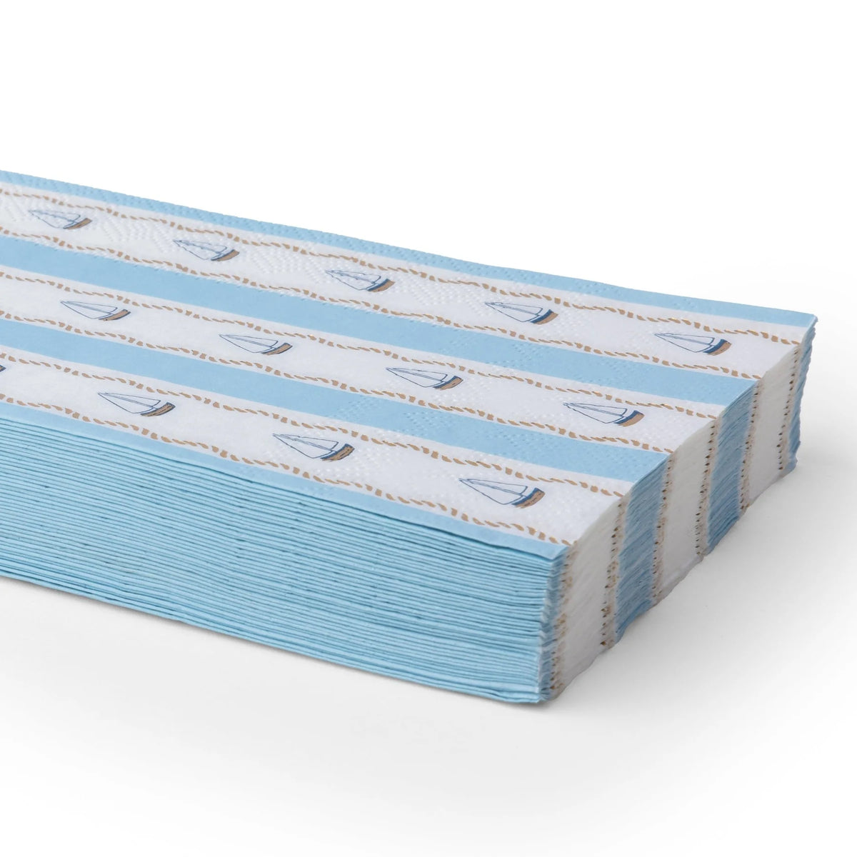 Stack of nautical sailboat paper guest towels with blue and white stripes, small navy sailboats, and gold rope detailing.