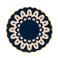 Navy dinner plate with an ivory folk doily medallion and gold scalloped rim on a white background