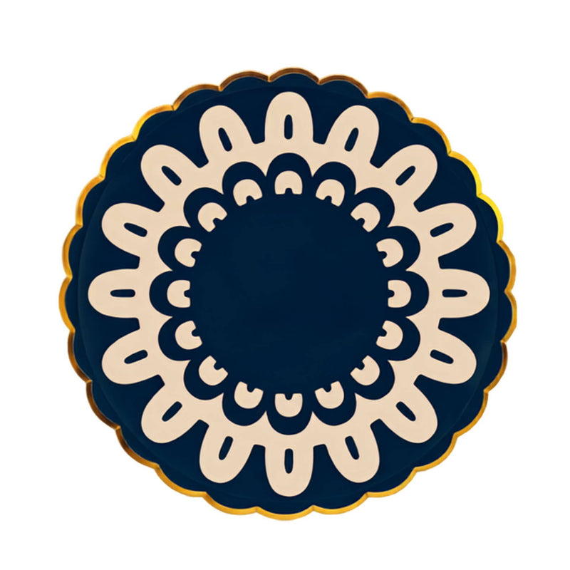 Navy dinner plate with an ivory folk doily medallion and gold scalloped rim on a white background