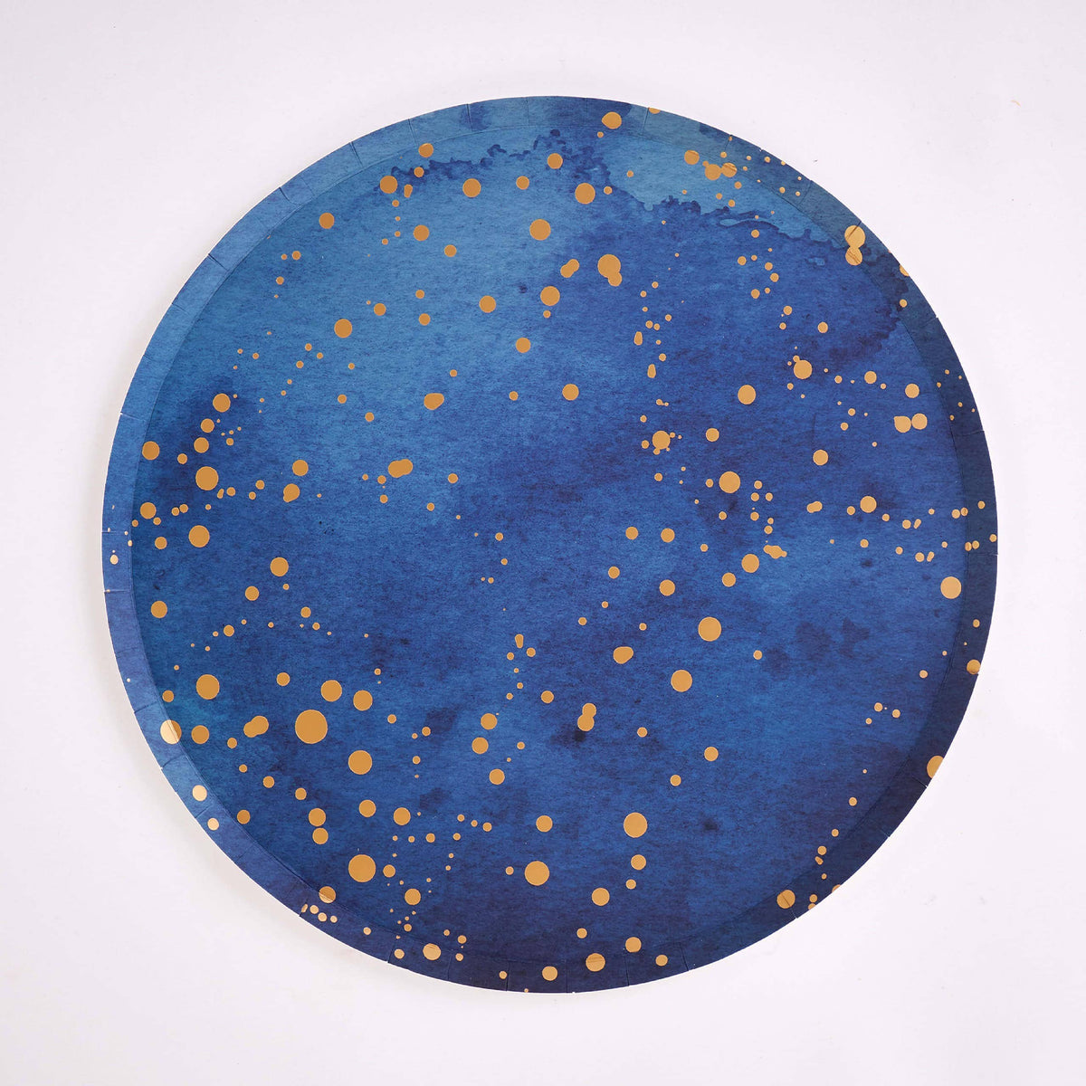 Single navy paper dinner plate with scattered gold-foil speckle on white