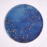 Single navy paper dinner plate with scattered gold-foil speckle on white