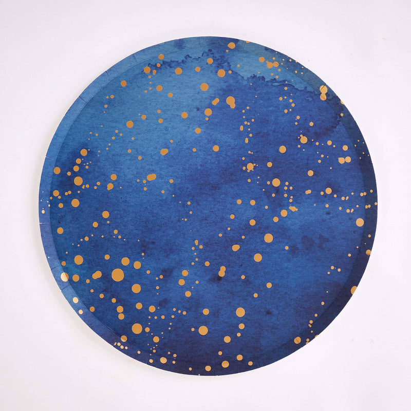 Single navy paper dinner plate with scattered gold-foil speckle on white