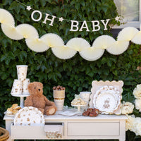 Neutral baby shower table setup with teddy bear party plates