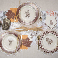 close up fall place setting with scalloped paper placemat and autumn décor
