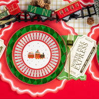 Detail of plate stack and pinecones with ticket napkin