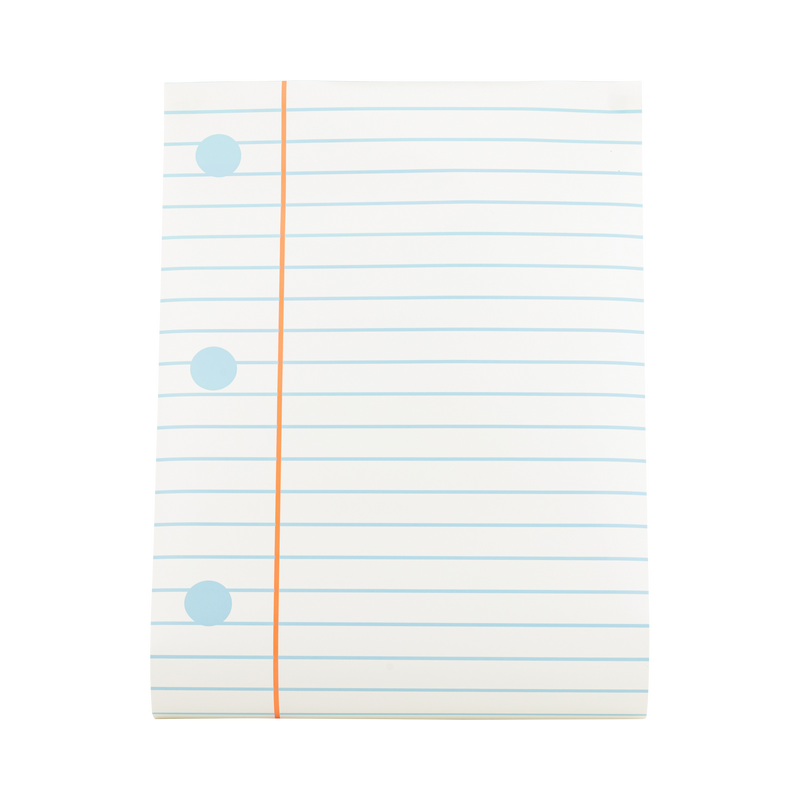 Close-up of notebook paper table runner showing cream background with pale blue ruled lines, orange margin, and three blue hole-punch dots