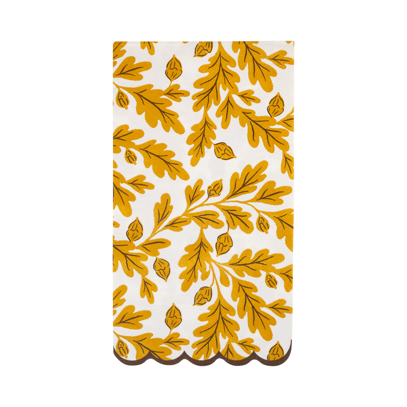 Cream dinner napkin with yellow and brown oak leaves and a brown scalloped edge, front view.