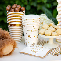 Gold and tan Oh Baby napkins with cups and dessert display