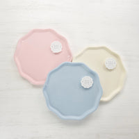 Packaged compostable plates in petal pink, sky blue, and cream—Bonjour Fête Signature Line.