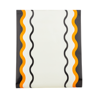 Orange, black, and cream ric-rac stripe paper table runner, shown flat to display the pattern.