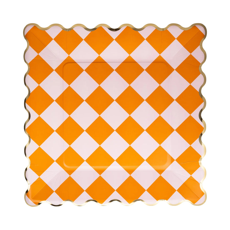 Orange and white checkered plate with scalloped edge on a white background