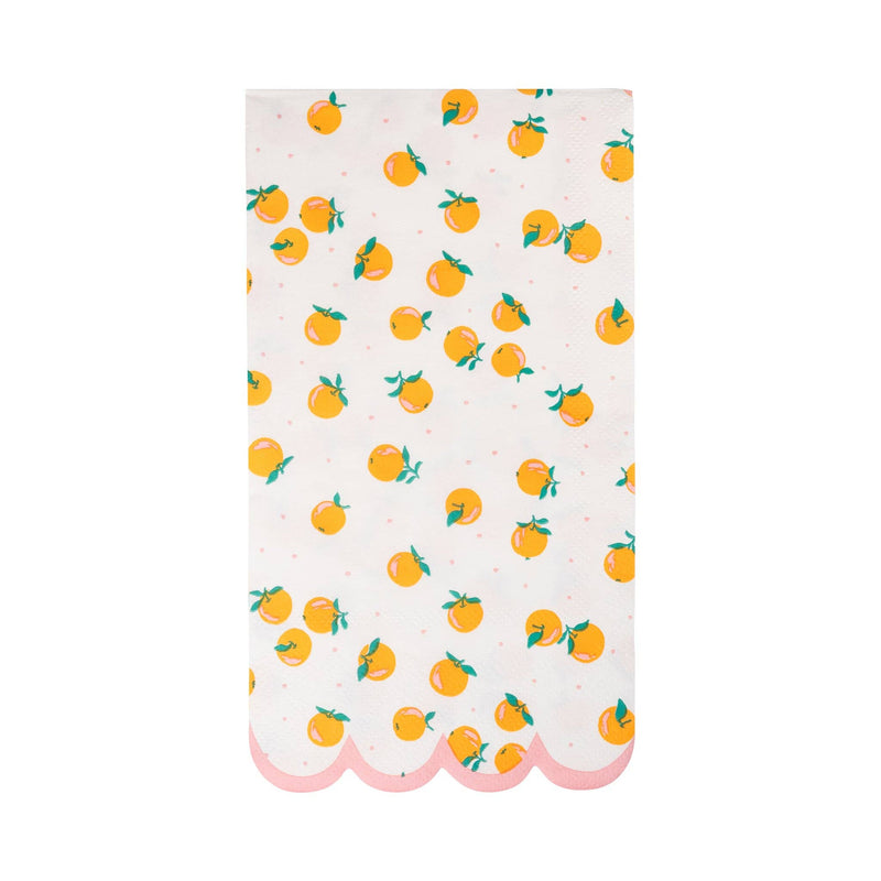 Orange dinner napkin with scattered citrus print and pink scalloped border.

