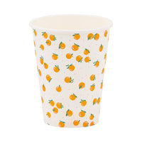 Orange print paper party cup with small citrus illustrations on a cream background.
