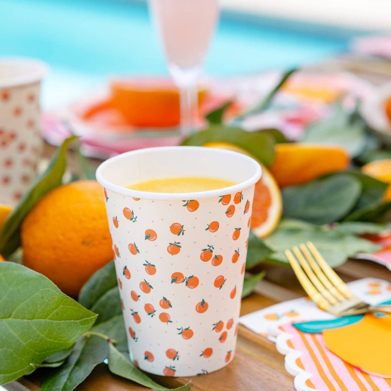 Orange themed party cup styled on a citrus summer party table.