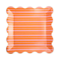 Orange and pink striped scalloped paper plate.
