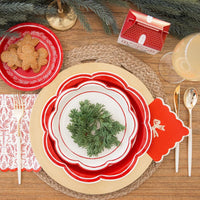 Overhead view of a complete holiday table setting featuring the cream and red disposable dinner plates and cottage treat box.