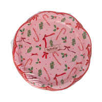 Front of the packaged set of 8 pink Christmas plates displaying the pattern and scalloped shape.