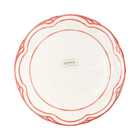 Front of the packaged set of 8 red and white plates displaying the distinct scalloped edge.