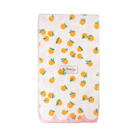 Packaged orange dinner napkins with scattered orange print.
